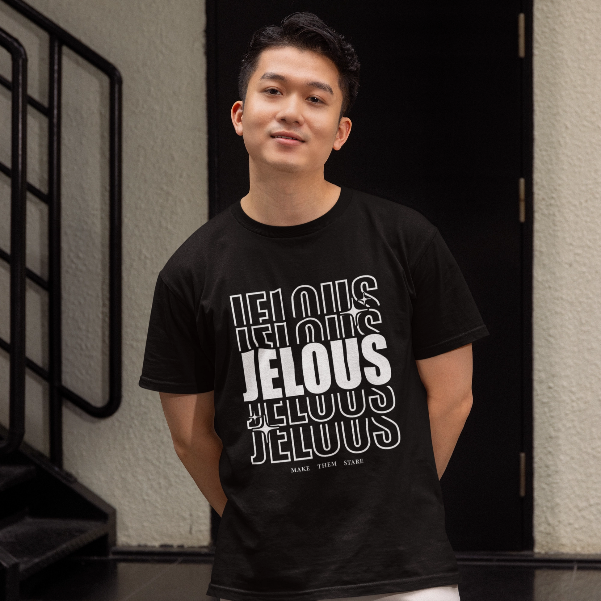 Man wearing JELOUS Echo Tee in black with bold stacked logo design, casual fit cotton t-shirt