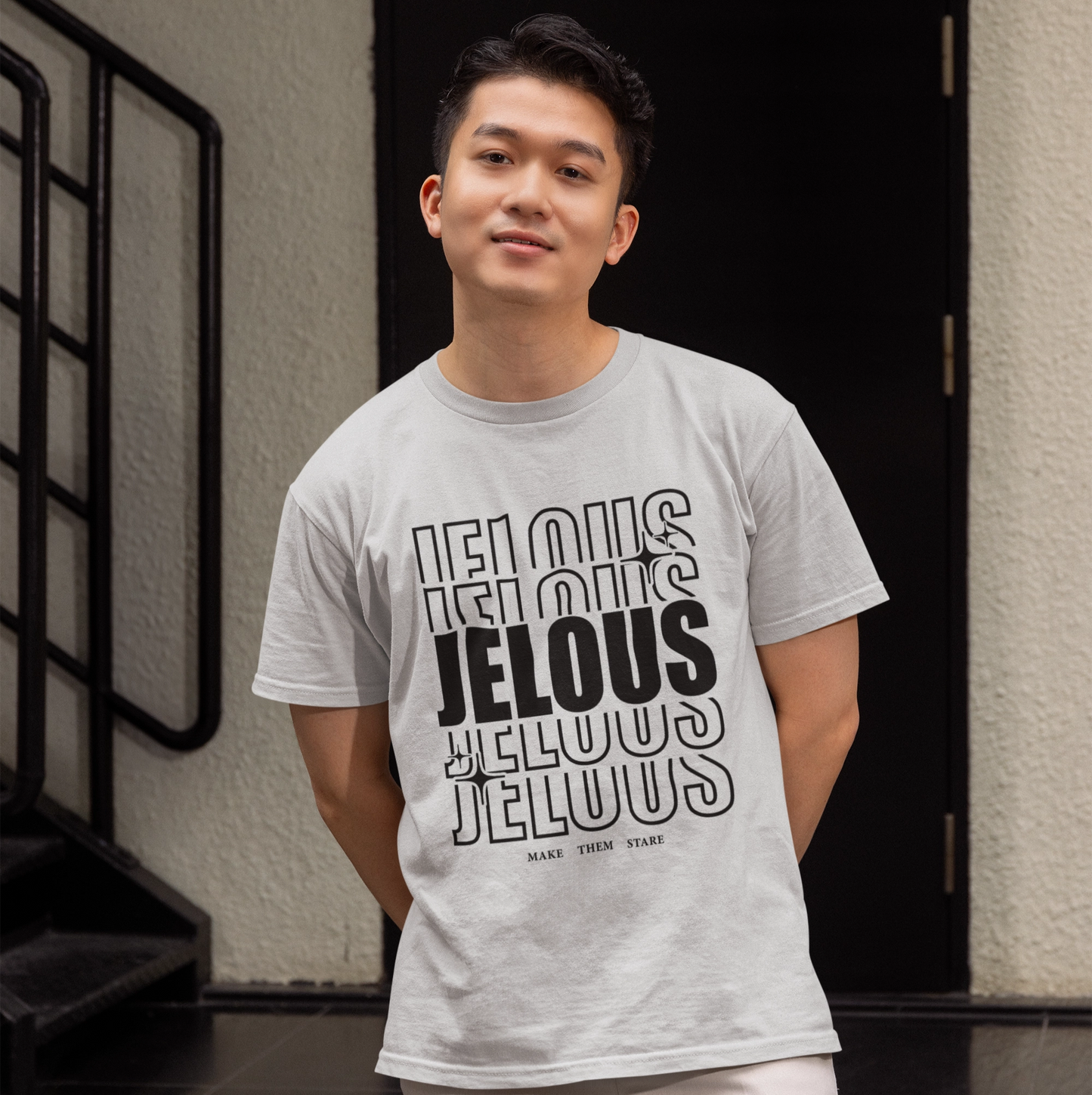 Man wearing JELOUS Echo Tee in grey with bold stacked logo design, casual fit cotton t-shirt