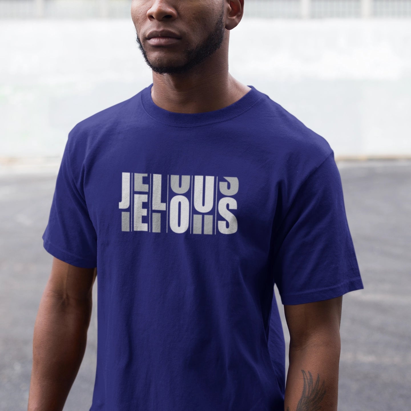 Man wearing a blue JELOUS Grid blue Tee with bold white print, casual short-sleeve 100% cotton regular fit t-shirt for men