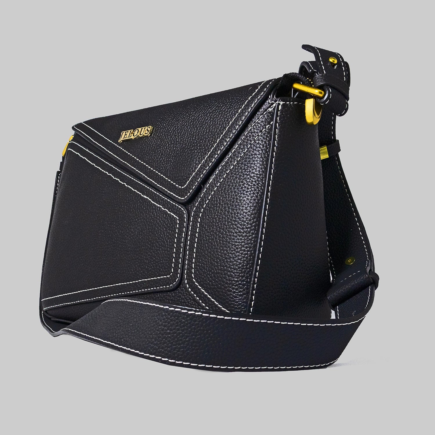 Black genuine cowhide leather handbag named The Jelous Astra with a geometric front flap, magnetic closure, and two detachable straps.
