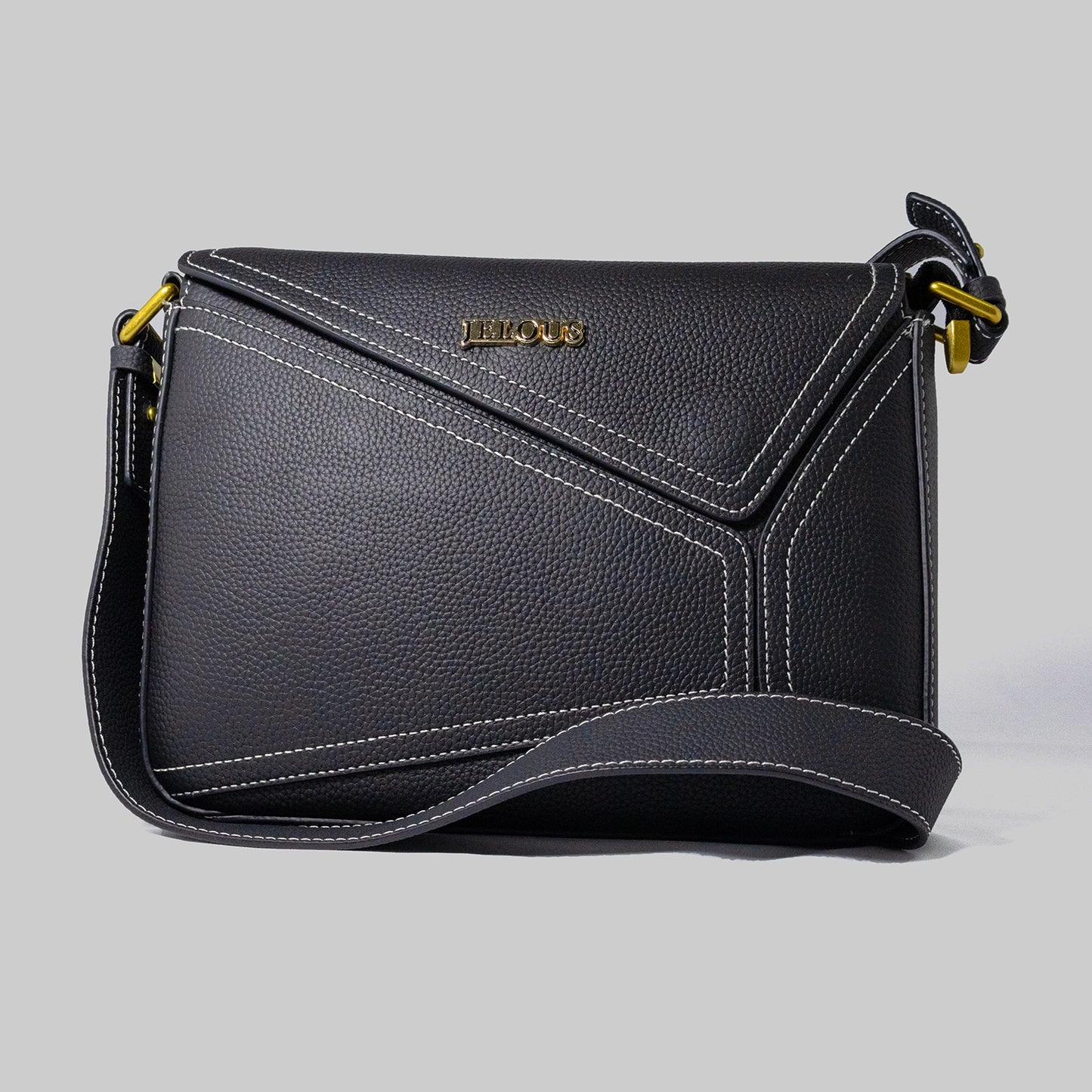 Black genuine cowhide leather handbag named The Jelous Astra with a geometric front flap, magnetic closure, and two detachable straps.
