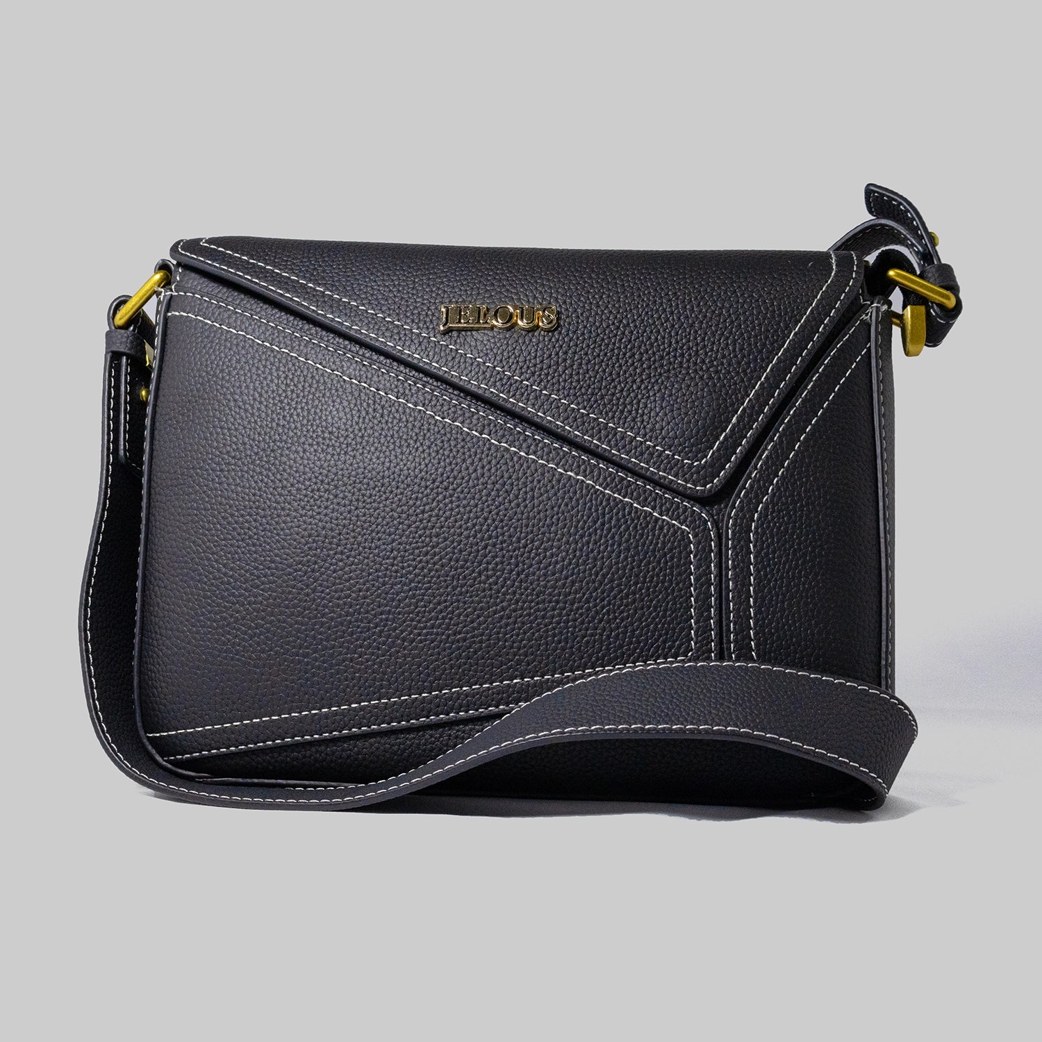 Black genuine cowhide leather handbag named The Jelous Astra with a geometric front flap, magnetic closure, and two detachable straps.